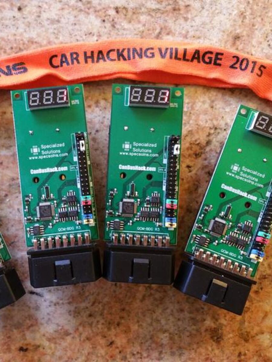 2015 DEF CON 23 badge boards with OBD-II connectors and three-digit displays