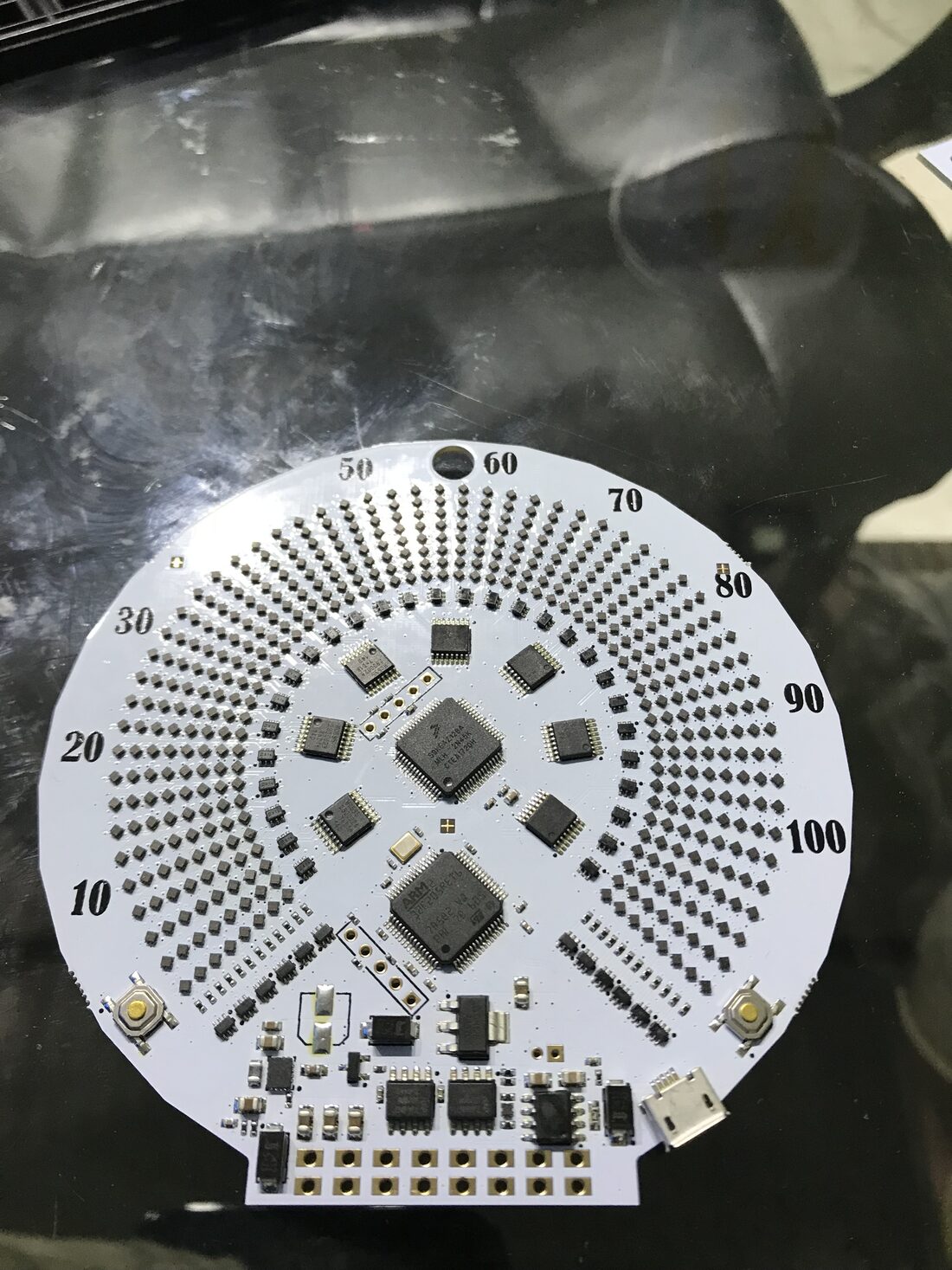 Assembled white speedometer board with LEDs, microcontrollers, buttons and a micro-USB connector